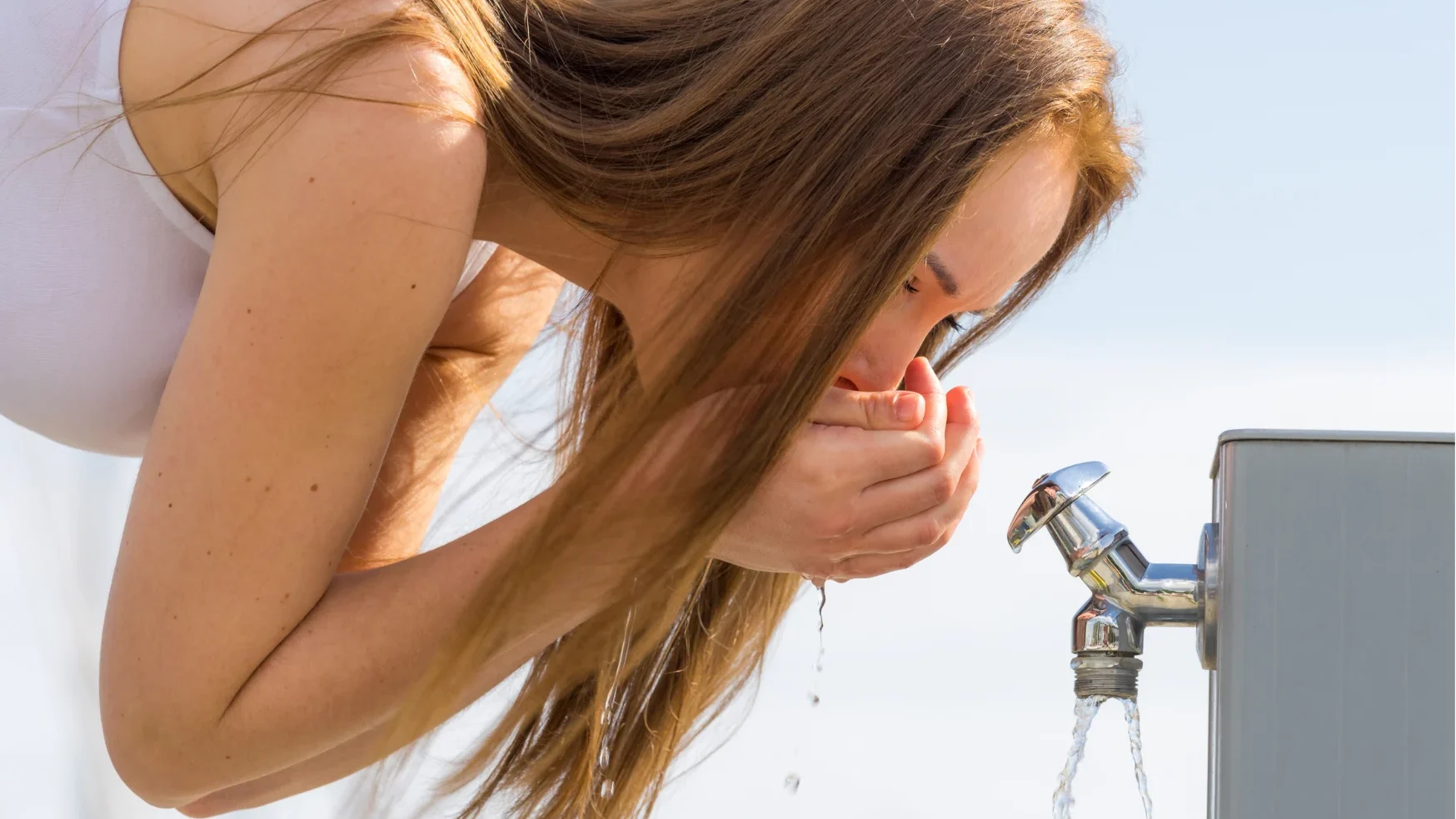 Cloudy tap water flowing from a kitchen faucet in Tampa, Florida, illustrating common water quality issues such as sediment, hard water, and trapped air.